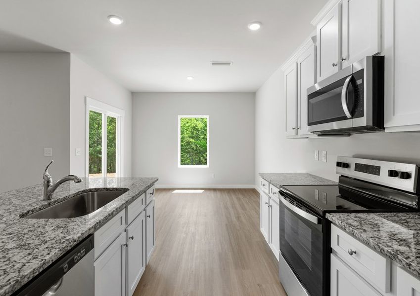 The kitchen leads to the dining area