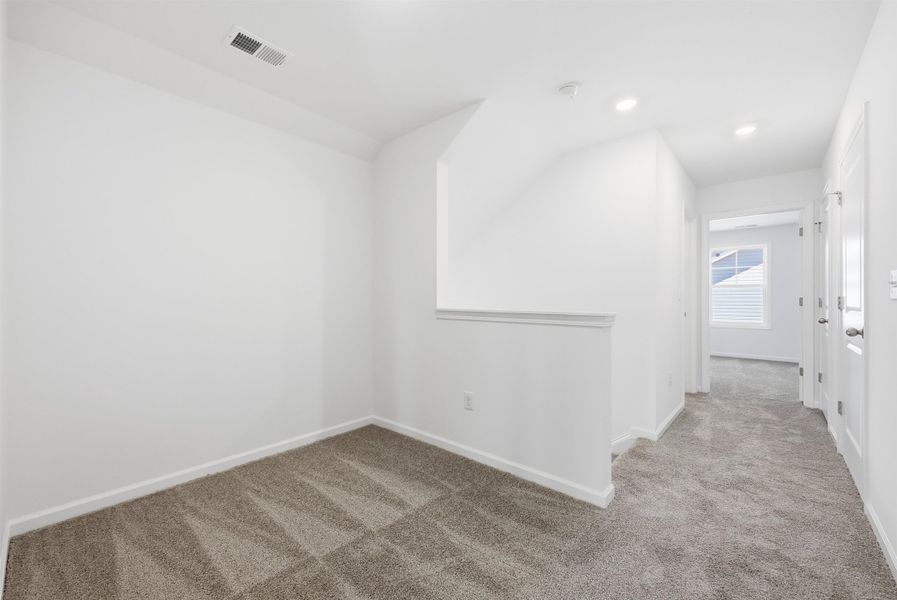 Carpeted spare room featuring baseboards and recessed lighting Carpeted spare room featuring baseboards and recessed lighting