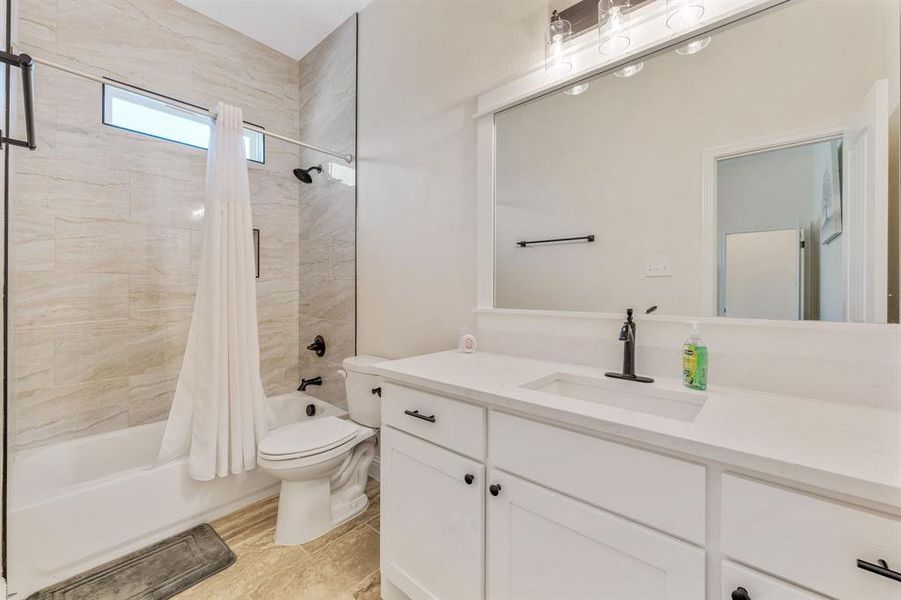 Full bathroom featuring shower / tub combo and vanity Full bathroom featuring shower / tub combo and vanity