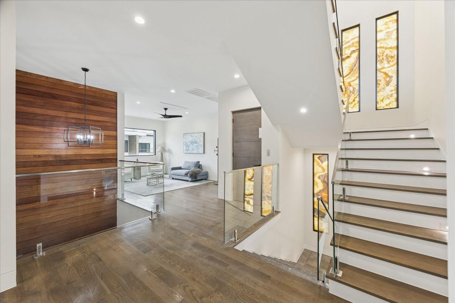 Experience the elegance of the second floor, featuring onyx stone accents and sleek glass railings that enhance the open space.