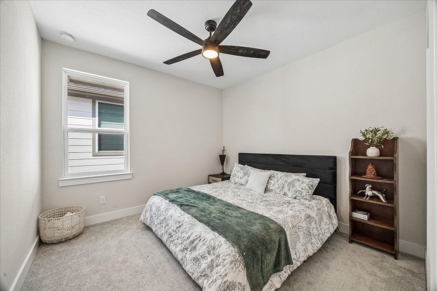 Another well-appointed upstairs bedroom offers a flexible layout ideal for guests, family members, or a quiet home office.