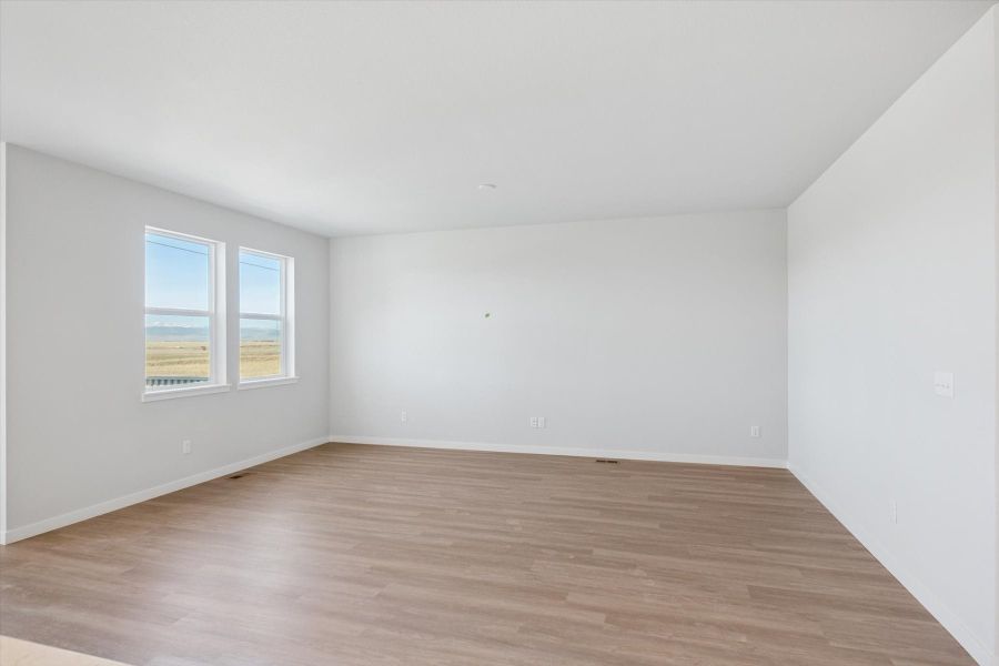 A room with a wood floor and a window.