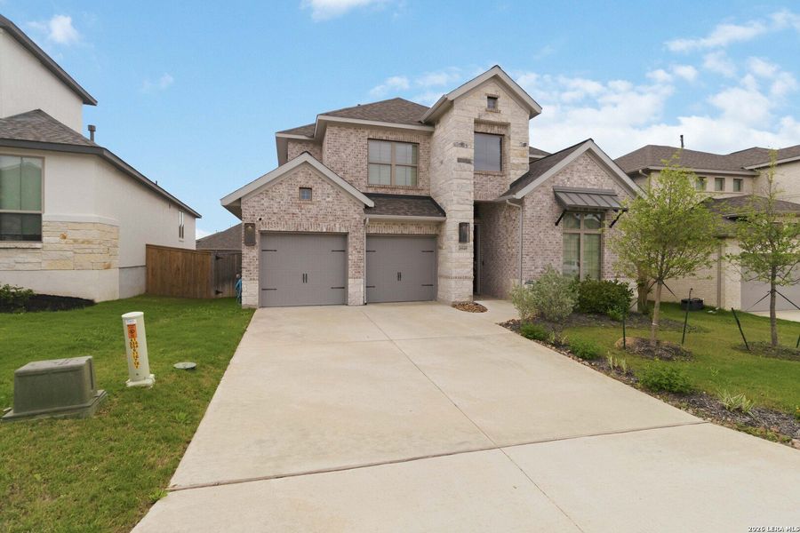 Front exterior of a new home in Kinder Ranch, San Antonio, TX, highlighting curb appeal (Image 18).