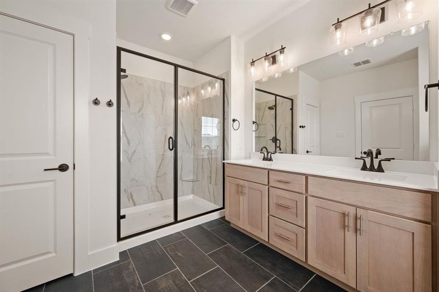 Vanity space for 2 and a spacious walk in shower are only a few of the thoughtful design elements you will find in this beautiful Owner's Suite.