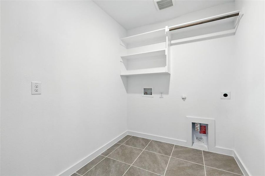 Laundry area featuring hookup for a gas dryer, washer hookup, electric dryer hookup, and tile patterned flooring