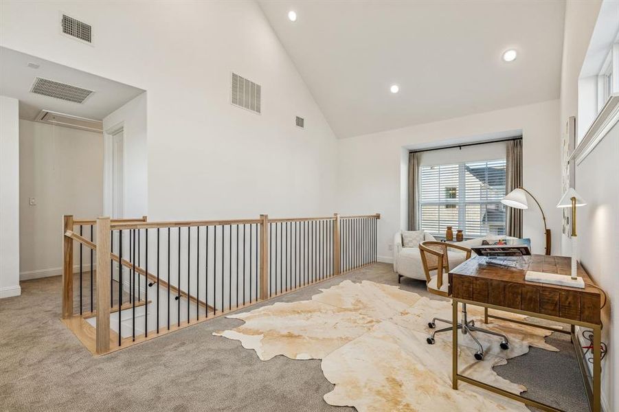 Home office with carpet flooring, vaulted ceiling, and recessed lighting