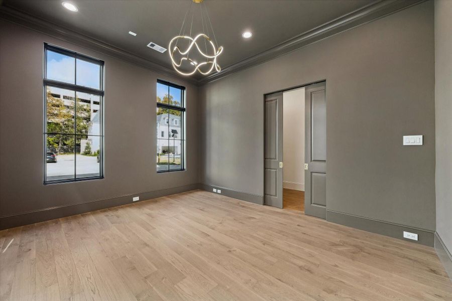 Off the entry is the dedicated office or formal dining. Designer light fixture, spacious closet, and pocket doors complete this space.