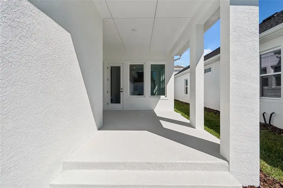 Exterior details and patio area of a home in Emerald Landing at Waterside at Lakewood Ranch – Cottage Series, Sarasota (Image 4).