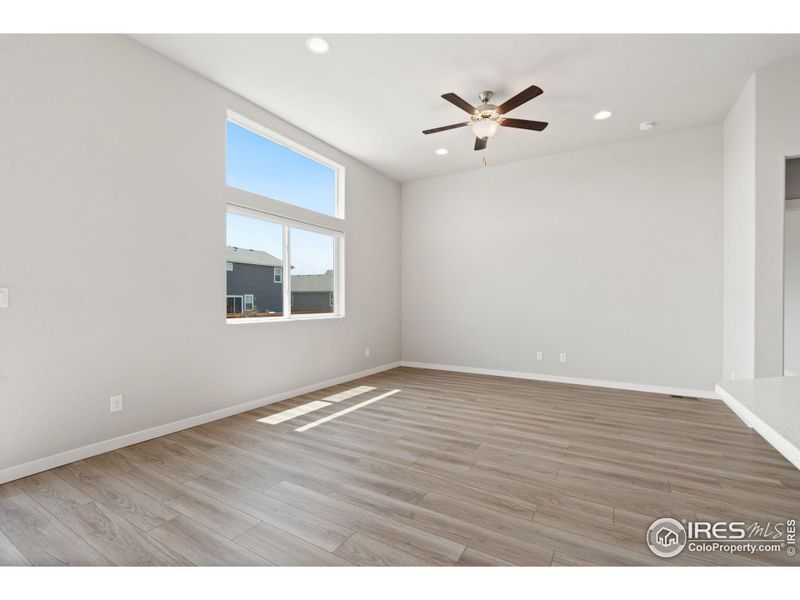 Living room has great natural light and ceiling fan