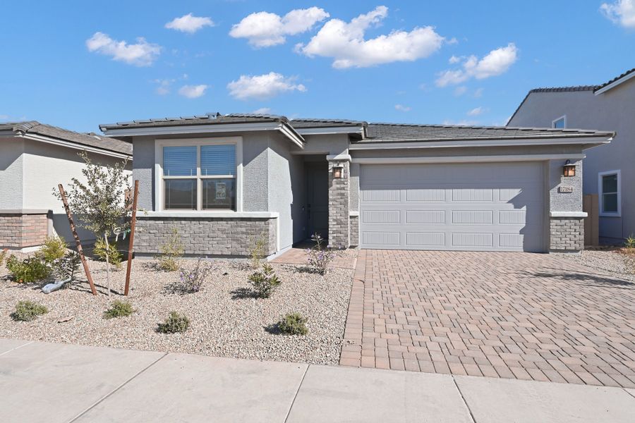 Front exterior of a new home in Artisan at Asante, Surprise, AZ, highlighting curb appeal (Image 1). Front exterior of a new home in Artisan at Asante, Surprise, AZ, highlighting curb appeal (Image 1).