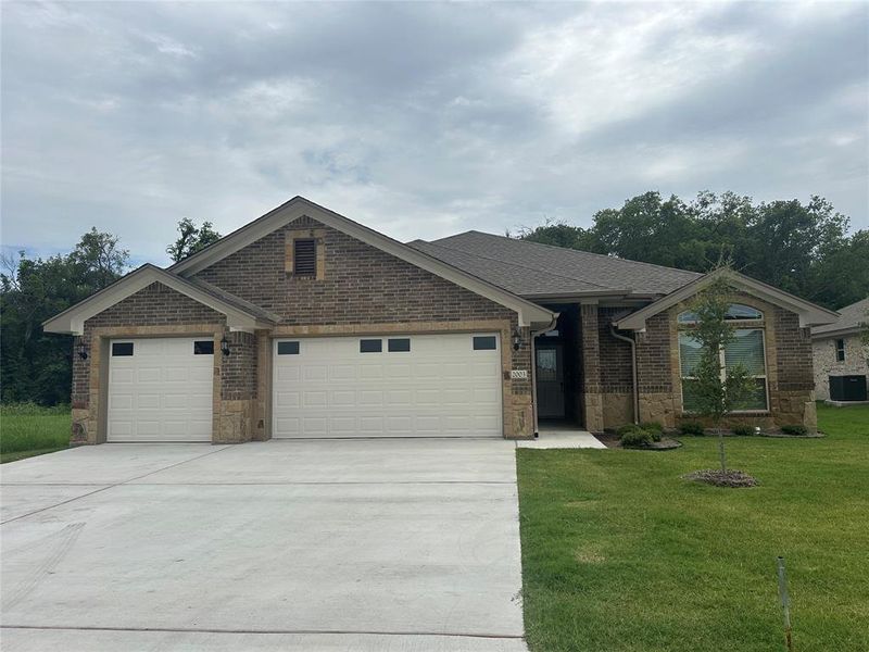 Ranch-style house featuring an attached garage, brick siding, driveway, a front yard, and roof with shingles Ranch-style house featuring an attached garage, brick siding, driveway, a front yard, and roof with shingles