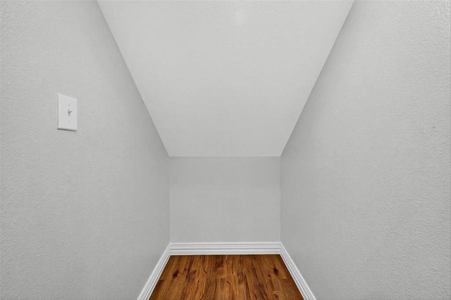 Detailed view of wood finished floors and a textured wall Detailed view of wood finished floors and a textured wall