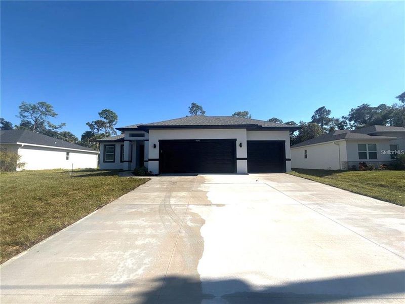 Front exterior of a new home in , North Port, FL, highlighting curb appeal (Image 1). Front exterior of a new home in , North Port, FL, highlighting curb appeal (Image 1).