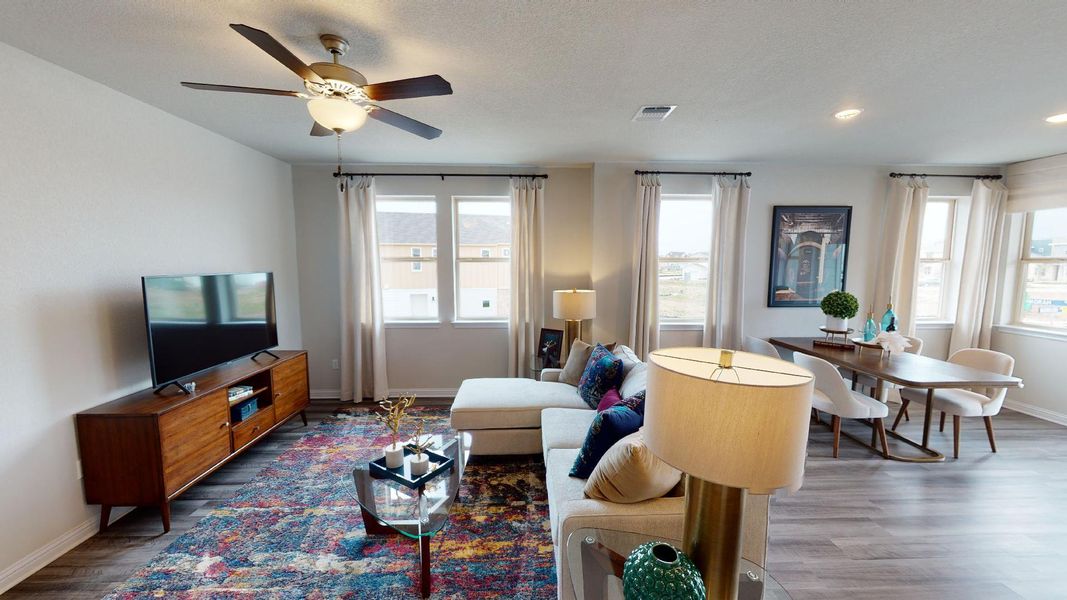 Living room featuring dark wood-style floors and a ceiling fan