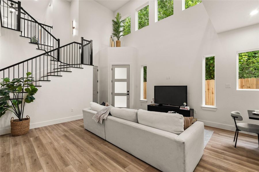 Rear of the living room — tall windows, backyard views, and two stories of natural light Rear of the living room — tall windows, backyard views, and two stories of natural light