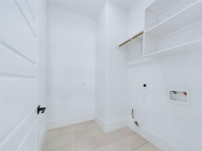 Efficiency meets organization inside of this laundry room complete with built-in shelving for optimal storage. A rod placed above the dryer offers an easy solution for your delicate garments that need to be air dried! *All interior photos are from the model home: 9007 Orange Springs Dr.*