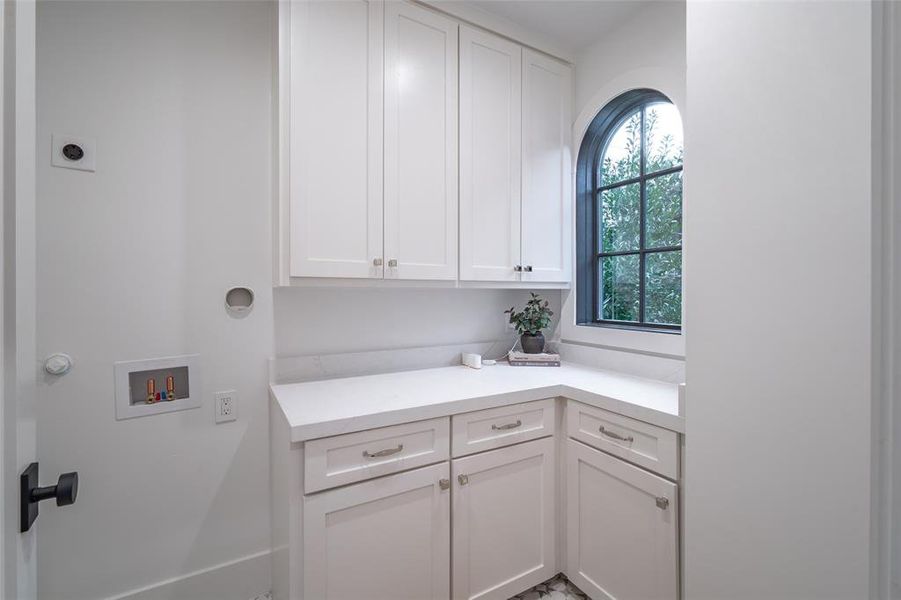 Laundry area featuring hookup for a washing machine, cabinets, and hookup for an electric dryer