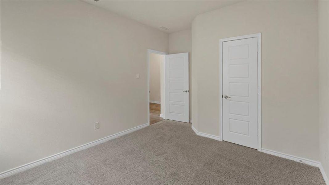Unfurnished bedroom featuring carpet flooring and baseboards Unfurnished bedroom featuring carpet flooring and baseboards