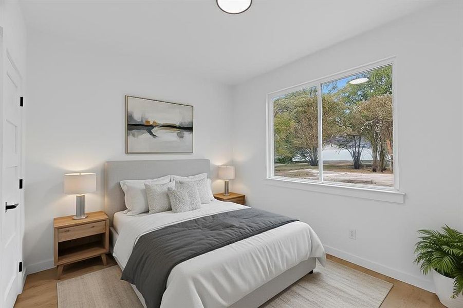 Bedroom featuring light wood-style flooring and baseboards Bedroom featuring light wood-style flooring and baseboards