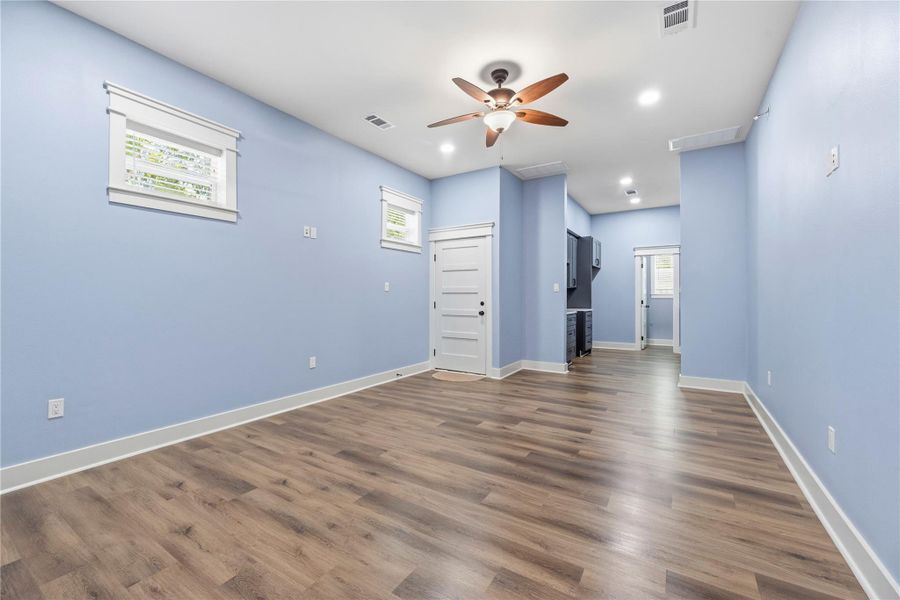 Spacious living room within the private living quarters featuring soaring ceilings, private entry access, and an open-concept layout designed for comfort.