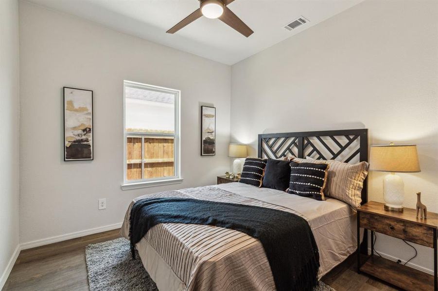 Bedroom with ceiling fan and hardwood / wood-style floors