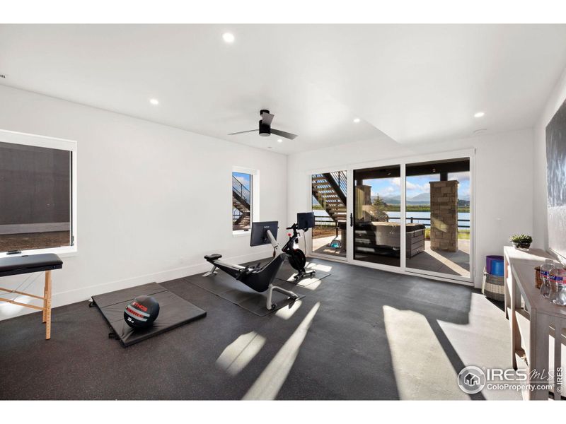 Fitness Room with Athletic Flooring & Slider to Patio