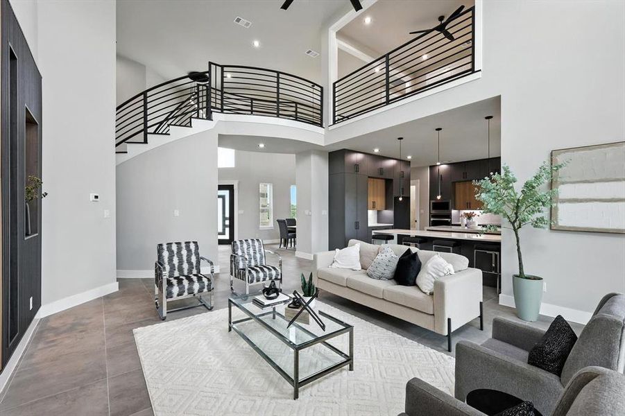 Living area with a high ceiling and stairway