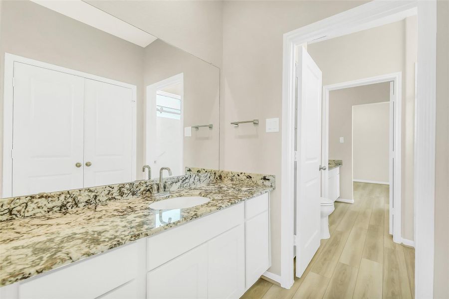 Consistent quality throughout the home is seen in this secondary bath other side of the Jack and Jill layout, offering plenty of storage and premium countertop space.