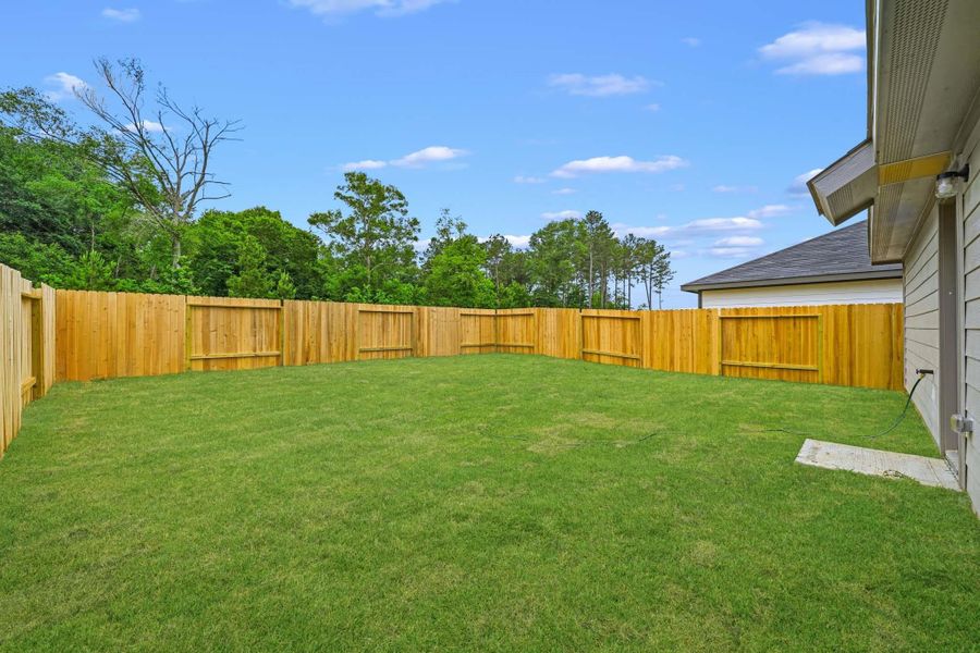 Exterior details and patio area of a home in The Canopies, Splendora (Image 4).