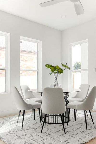 Dining space featuring ceiling fan and light wood-type flooring