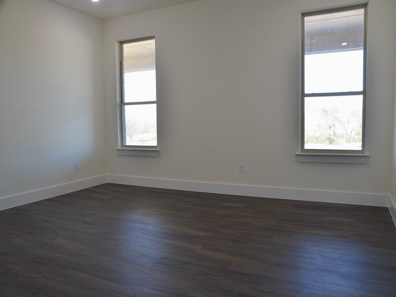 Spare room with dark wood-type flooring