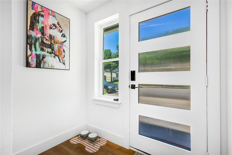 Doorway with hardwood / wood-style flooring