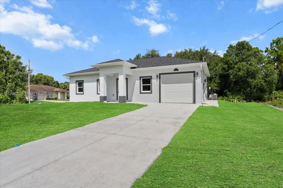 Front exterior of a new home in , Lehigh Acres, FL, highlighting curb appeal (Image 2). Front exterior of a new home in , Lehigh Acres, FL, highlighting curb appeal (Image 2).