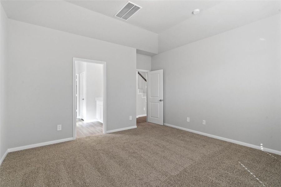 The private primary suite efficiently connects the sleeping area with the dedicated bathroom and generous closet.