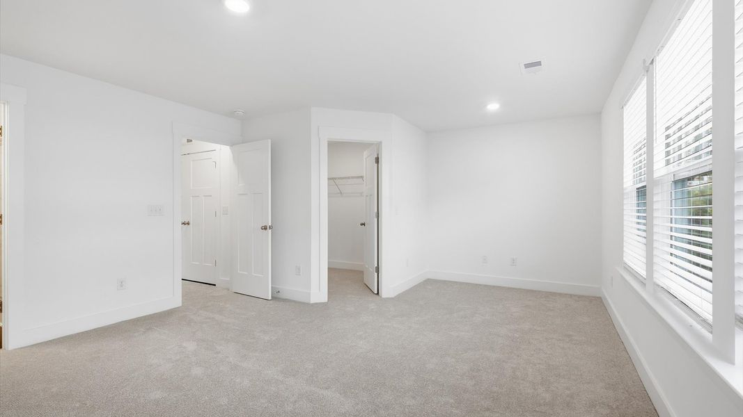 Vibrant natural light fills this exceptional primary suite with eye-catching details