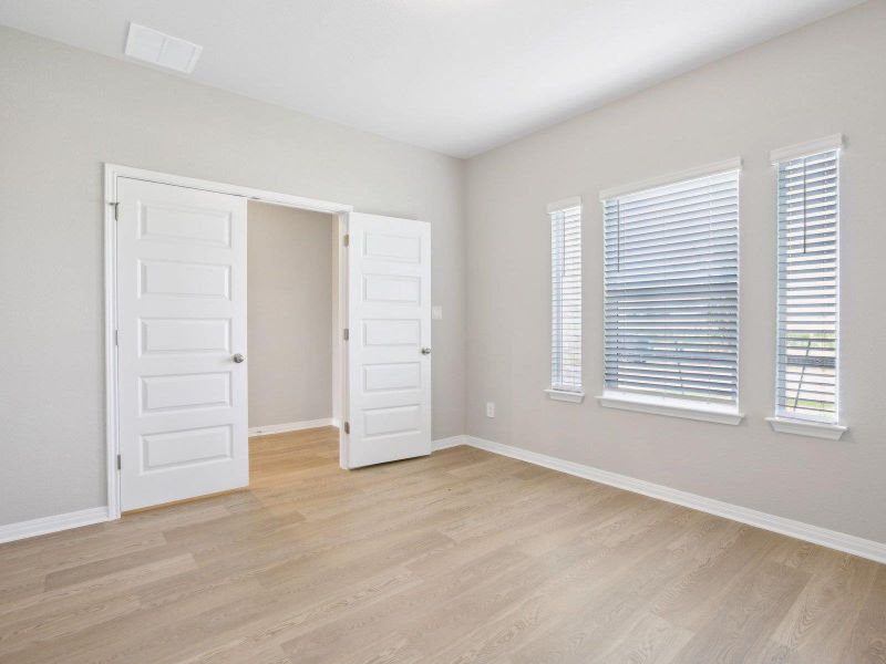 Unfurnished bedroom with light wood finished floors and baseboards Unfurnished bedroom with light wood finished floors and baseboards