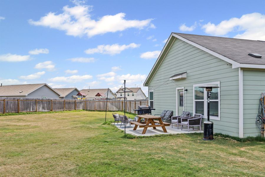 Fenced backyard with a patio and a residential view Fenced backyard with a patio and a residential view
