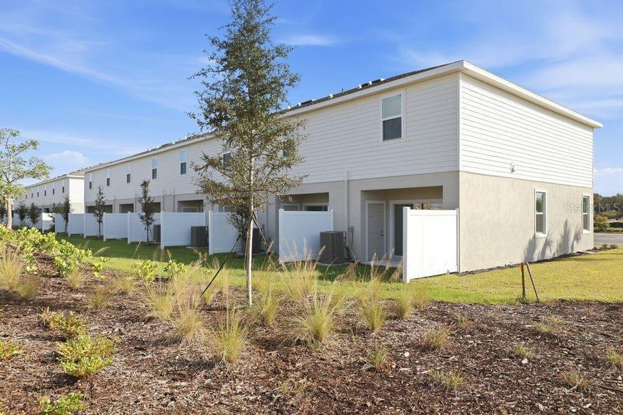 Exterior details and patio area of a home in The Towns at Firethorn, Parrish (Image 26).