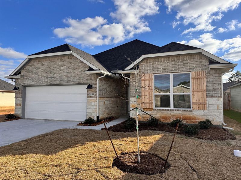 Front exterior of a new home in Grand Oaks Reserve, Cleveland, TX, highlighting curb appeal (Image 2). Front exterior of a new home in Grand Oaks Reserve, Cleveland, TX, highlighting curb appeal (Image 2).