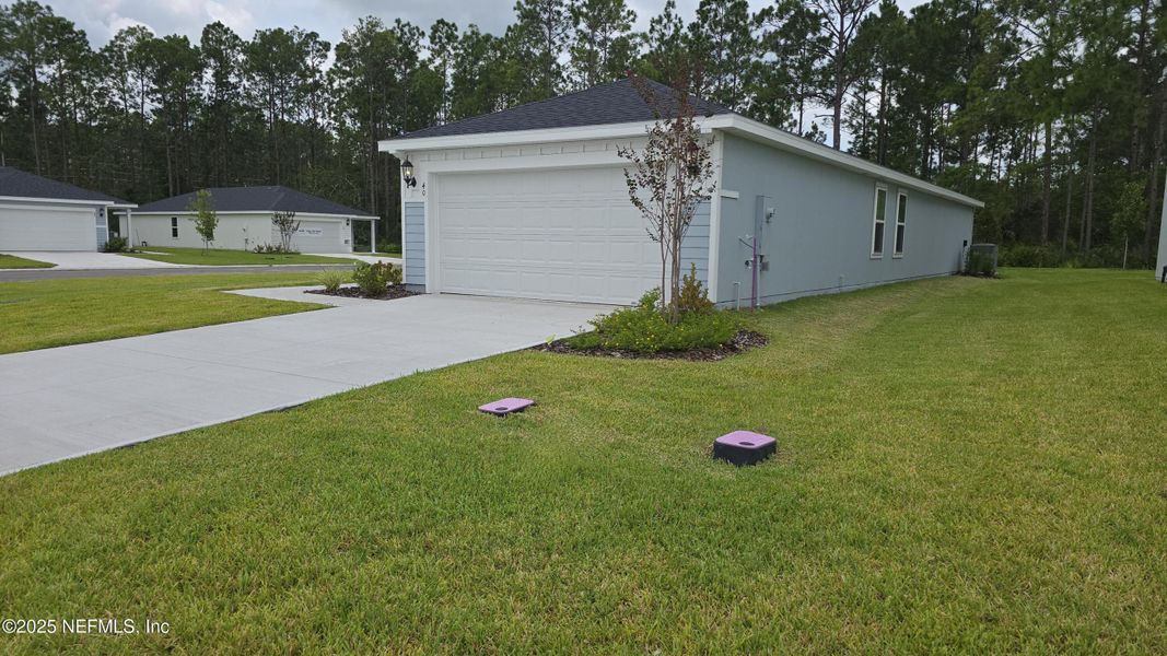 Front exterior of a new home in Flagler Village - Classic Series, Palm Coast, FL, highlighting curb appeal (Image 26). Front exterior of a new home in Flagler Village - Classic Series, Palm Coast, FL, highlighting curb appeal (Image 26).