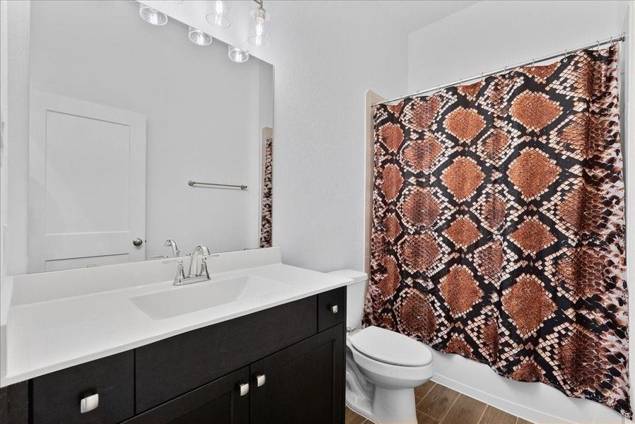 The third full bathroom is conveniently located off the family room near the fourth bedroom and features a tub/shower combination, making it ideal for guests or flexible living needs. The third full bathroom is conveniently located off the family room near the fourth bedroom and features a tub/shower combination, making it ideal for guests or flexible living needs.