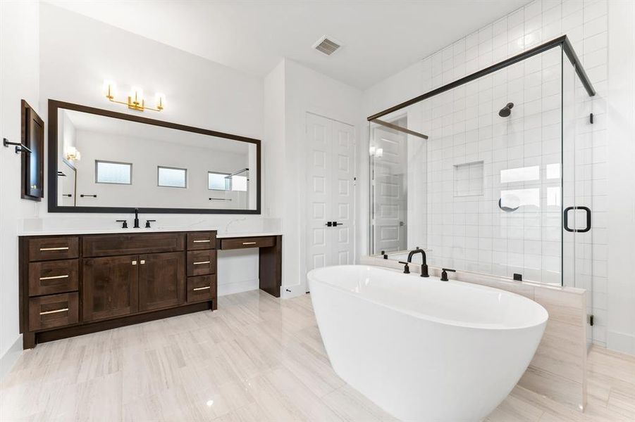 Primary Bath with Freestanding Tub, Linen Closet, and 1 of 2 Vanities.