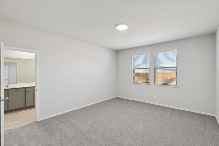 Primary Bedroom in the Holden home plan by Trophy Signature Homes – REPRESENTATIVE PHOTO
