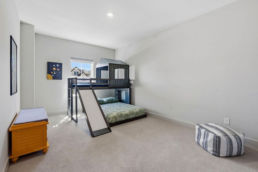 Bedroom featuring baseboards and light carpet Bedroom featuring baseboards and light carpet