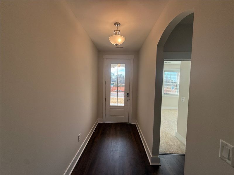 Enter into a welcoming hallway with rich flooring