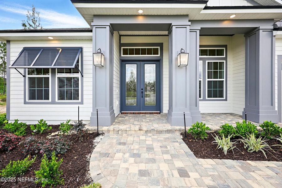 Front exterior of a new home in Courtney Oaks in SilverLeaf, St. Augustine, FL, highlighting curb appeal (Image 23). Front exterior of a new home in Courtney Oaks in SilverLeaf, St. Augustine, FL, highlighting curb appeal (Image 23).