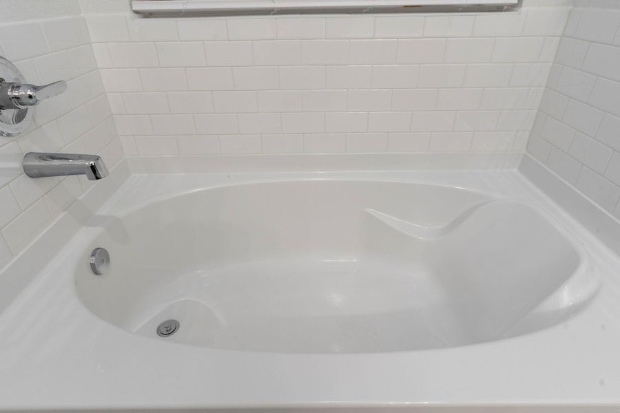 A closer look at the relaxing soaking tub shows its beautiful tile surround and clean design. Perfect for a soothing bath with a touch of everyday luxury.