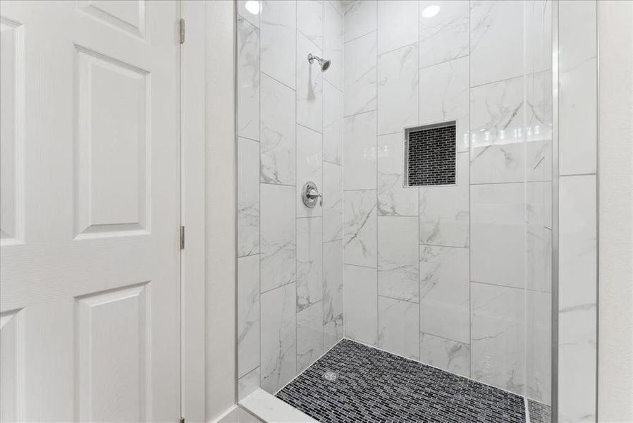 Bathroom featuring a tile shower