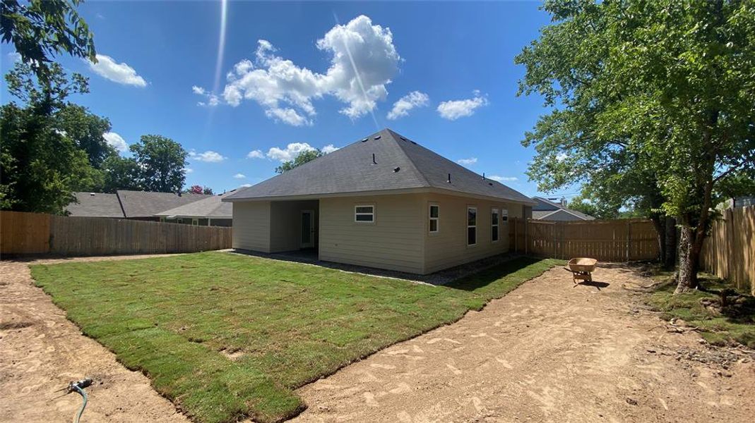 Back of house featuring a yard