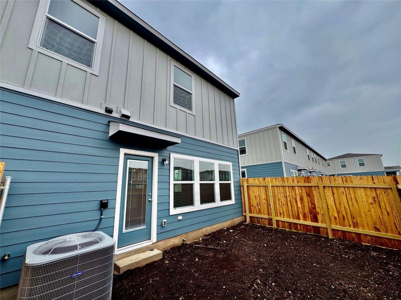 Rear view of house featuring board and batten siding